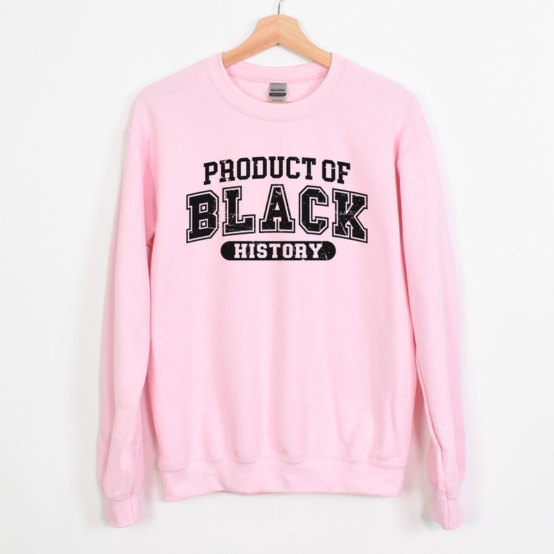 May include: Pink sweatshirt with black text that reads "Product of Black History".