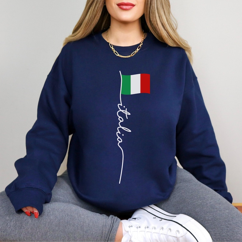May include: A navy blue sweatshirt with a white graphic of the Italian flag and the word "italia" written vertically.
