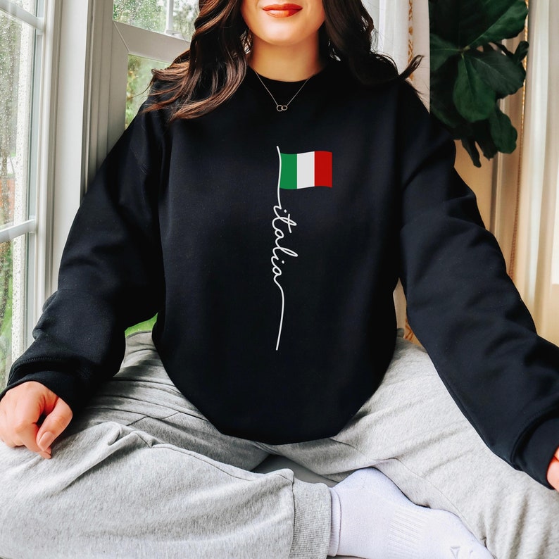 May include: Black sweatshirt with a white graphic of the Italian flag and the word "Italia" written vertically.