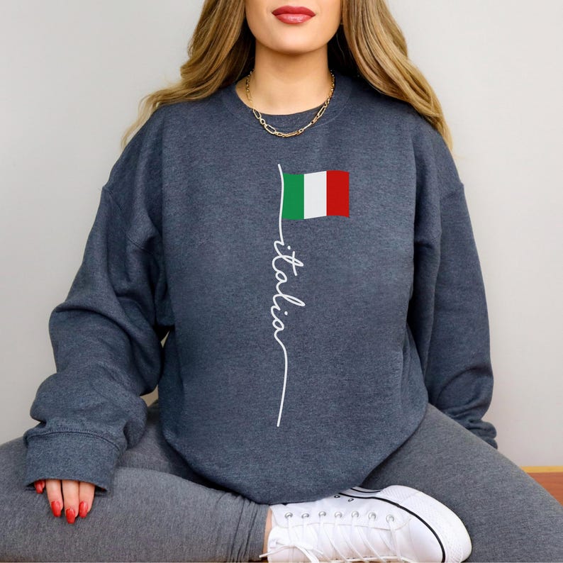 May include: A dark gray sweatshirt with a white graphic of the Italian flag and the word "italia" written vertically.