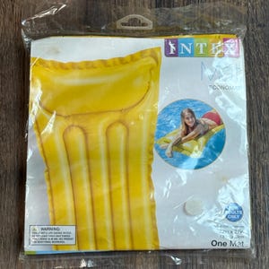 May include: A yellow Intex Economat inflatable pool float packaged in a clear plastic bag. The packaging features the text Intex, Economat, For Adults Only, and dimensions of 72 inches by 27 inches, along with an image of a person on the float.
