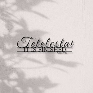 May include: Black and white typography on a white background with the words "Tetelestai" and "It is finished" with the scripture reference "John 19:13".