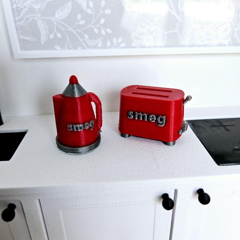 May include: Red Smeg brand electric kettle and toaster, both with the Smeg logo on the front.