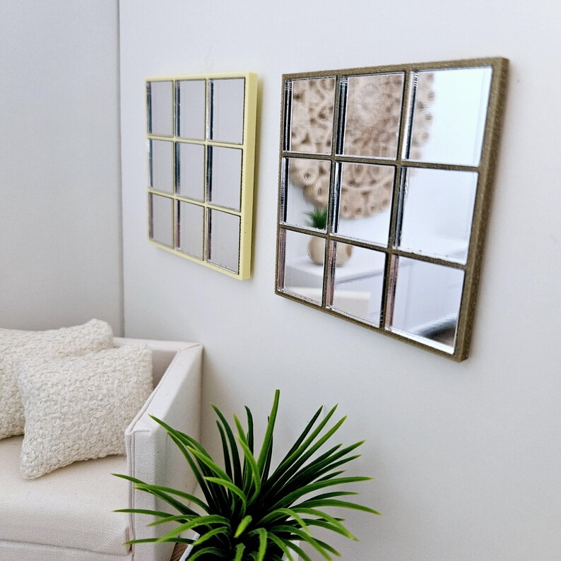 May include: Two square mirrors with a grid pattern. The mirror on the left has a light yellow frame, and the mirror on the right has a brown frame.