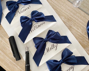 Handwritten Wedding Place Cards | white folded place card with navy blue ribbon