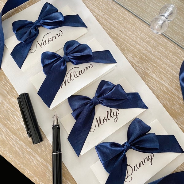 Handwritten Wedding Place Cards | white folded place card with navy blue ribbon