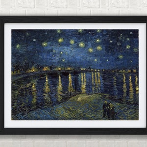 May include: A framed print of Van Gogh's "Starry Night Over the Rhone" shows a dark blue night sky with stars. The painting depicts a river reflecting the lights of a town, with two figures on the riverbank. The artwork is in a black frame.