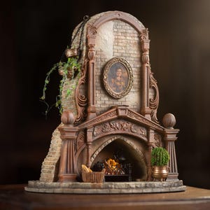 May include: A miniature fireplace with a brick facade, ornate carvings, and a working fireplace. The fireplace has a small portrait of a woman in a gold frame above it. There are small potted plants on either side of the fireplace.