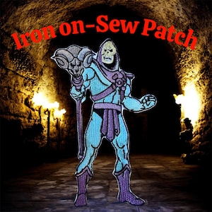 May include: An embroidered patch featuring a cartoon character with a skull face, wearing a blue and purple outfit, and holding a staff with a ram's head. The text "Iron on-Sew Patch" is arched above the character in red.