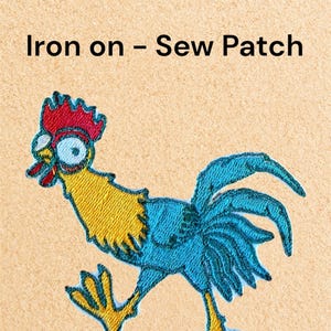 May include: Embroidered patch featuring a cartoon rooster with blue, yellow, and red details. The rooster has wide eyes and an open beak. The text "Iron on - Sew Patch" is above the rooster.