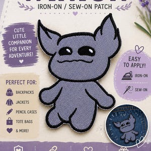 May include: A purple embroidered iron-on or sew-on patch featuring a stylised creature with large ears and black eyes. The patch is displayed on a promotional card with the text WINION, IRON-ON / SEW-ON PATCH, and various icons indicating application methods and uses.