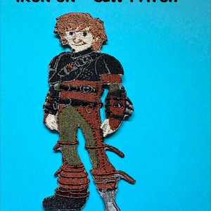 Pode incluir: Patch bordado com um personagem de desenho animado de cabelo ruivo, vestindo uma roupa preta e marrom. O patch é para passar a ferro ou costurar, com o texto "IRON ON - SEW PATCH" na parte superior.