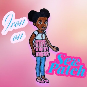May include: Embroidered patch featuring a cartoon girl in a pink tiered dress, blue leggings, and pink shoes. The patch has the words "Iron on" and "Sew Patch" in a cursive font. The background is a gradient of pink.