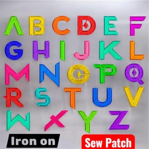May include: A collection of colorful embroidered alphabet letters, each in a different vibrant hue, arranged on a light gray surface. The letters are in a bold, block style, with the words "Iron on" and "Sew Patch" at the bottom.