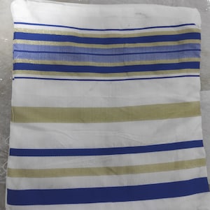 May include: White prayer shawl with blue and gold stripes.