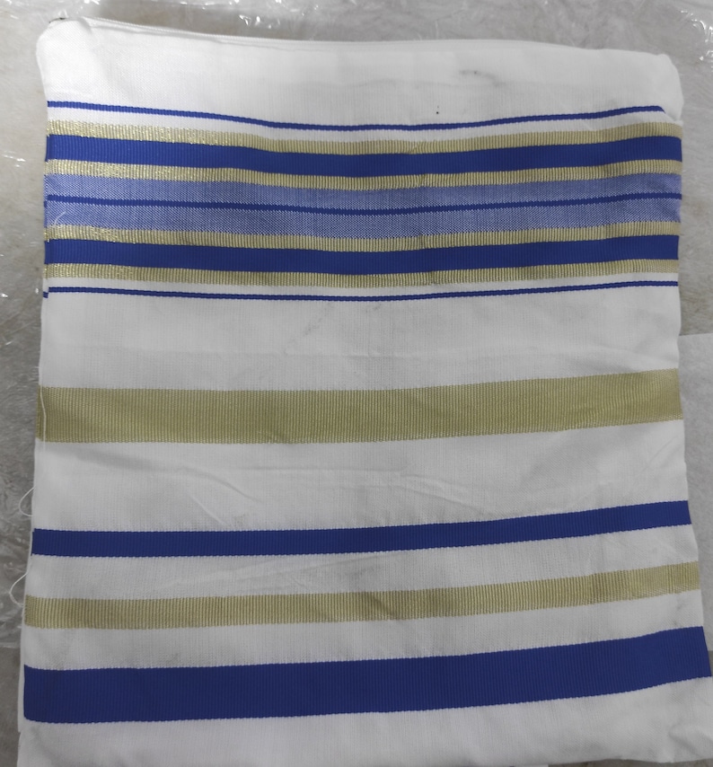 May include: White prayer shawl with blue and gold stripes.