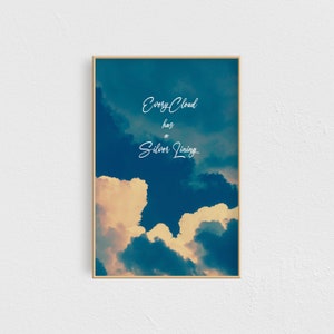 May include: A motivational quote, "Every Cloud has a Silver Lining", is displayed on a framed print with a background image of blue and yellow clouds.