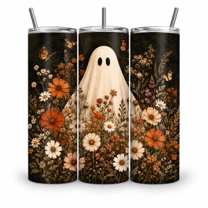 May include: A cylindrical tumbler with a lid and straw featuring a dark background printed with a white ghost figure surrounded by various orange, white, and brown wildflowers and several orange monarch butterflies scattered throughout the design.