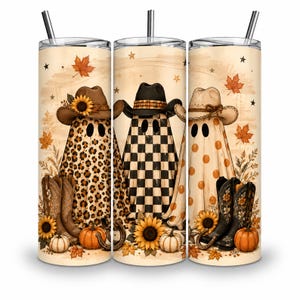May include: A cylindrical tumbler with a straw featuring a fall-themed design of three ghosts wearing cowboy hats. The ghosts are decorated with leopard print, black and white checkers, and orange polka dots, surrounded by sunflowers, pumpkins, and autumn leaves.