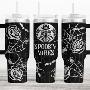 May include: Black tumbler with a handle, featuring a Halloween-themed design. The design includes a spider web, roses, bats, and the words "Spooky Vibes". The tumbler has a silver lid and a black handle.