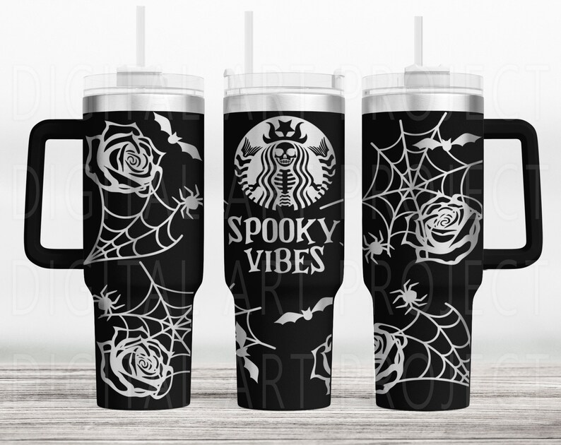 May include: Black tumbler with a handle, featuring a Halloween-themed design. The design includes a spider web, roses, bats, and the words "Spooky Vibes". The tumbler has a silver lid and a black handle.