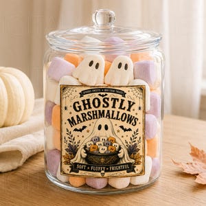 May include: A clear glass jar with a lid filled with white, orange, and purple marshmallows shaped like ghosts. The jar features a label that reads GHOSTLY MARSHMALLOWS, SPOOKY SWEETS, BOO-TIFUL TREATS, and SOFT FLUFFY FRIGHTFUL with a ghost illustration.
