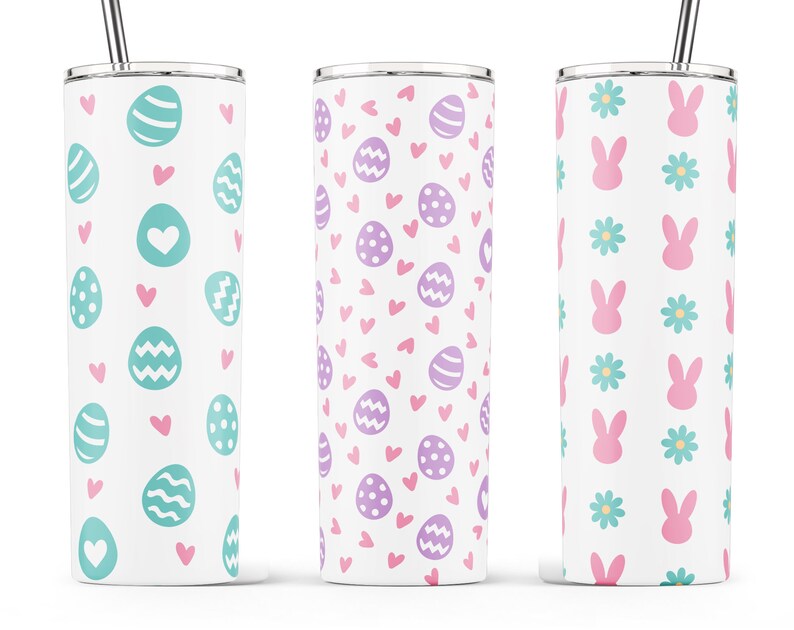 May include: Three stainless steel tumblers with different Easter-themed designs. The first tumbler has a pattern of teal eggs and pink hearts. The second tumbler has a pattern of purple eggs and pink hearts. The third tumbler has a pattern of pink bunnies and teal flowers.