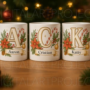 May include: Three white ceramic mugs with Christmas-themed designs. Each mug features a letter, a candy cane, poinsettias, and a banner with a name. The mugs are decorated with gold accents and festive holiday elements.