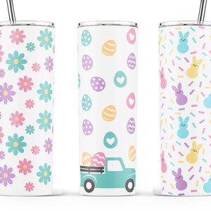 May include: Three stainless steel tumblers with different Easter-themed designs. The first tumbler has a pattern of pastel pink, purple, and blue flowers. The second tumbler has a pattern of pastel colored eggs and hearts with a turquoise truck carrying eggs. The third tumbler has a pattern of pastel colored bunnies and sprinkles.