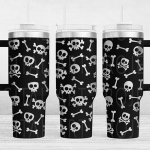 May include: Black travel mug with a white skull and crossbones pattern. The tumbler has a black handle and a clear lid. The design features various skull and bone illustrations, creating a spooky aesthetic.