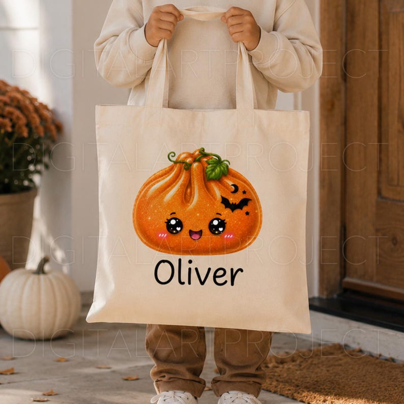 May include: A beige canvas tote bag featuring a graphic of a smiling orange pumpkin dumpling with a green leaf, a small black bat, and a crescent moon. The name Oliver is printed in black text below the pumpkin illustration.