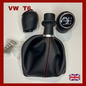 May include: A black leather gear shift knob with red stitching and a silver ring, a black leather gear shift boot with red stitching, and a black leather gear shift boot with red stitching and a silver ring. The gear shift knob has the numbers 1, 3, 5, R, 2, 4, 6, and 8 printed on it.