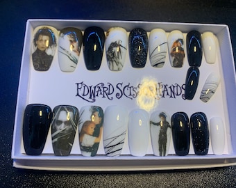 May include: A set of 12 false nails with a black and white design featuring images from the movie Edward Scissorhands. The nails are in a white box with the movie title printed on the front.