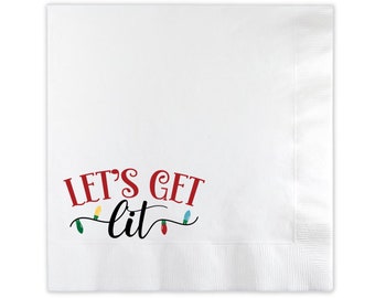May include: White paper napkin with the phrase "LET'S GET lit" in red and black script, with colorful string lights. The napkin is folded and has a textured edge.