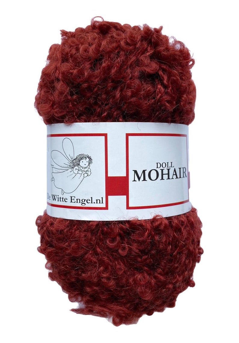 May include: A ball of dark red doll mohair yarn. The yarn has a curly, textured appearance. A white label with red accents wraps around the yarn, displaying the text "DOLL MOHAIR" and a logo of a fairy. The website "De Witte Engel.nl" is also printed on the label.
