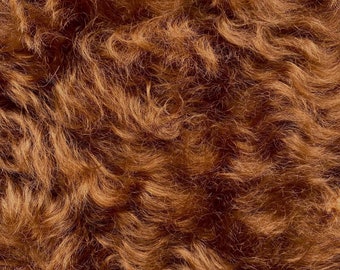 May include: Close-up texture of a reddish-brown fur. The fur is soft and fluffy, with a slightly wavy pattern.