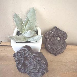 May include: A set of three ceramic mugs with a speckled, matte finish. The mugs are in shades of cream, light gray, and dark gray. Each mug has a simple, minimalist design and a rounded handle. The mugs are suitable for coffee, tea, or other beverages.