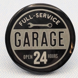 May include: Black and white round button with the text "Full-Service Garage Open 24 Hours" and a wrench icon.