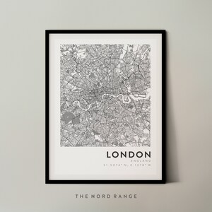May include: A black and white map print of London, England. The map shows the city's streets and landmarks. The text "LONDON" and "ENGLAND" are printed below the map, along with the coordinates "51.5074&deg; N, 0.1278&deg; W". The text "THE NORD RANGE" is printed below the coordinates.