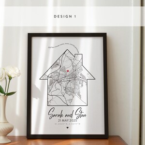 May include: A black framed print with a white background featuring a map of a city with a red heart marking a location. The text "Sarah and Steve 21 MAY 2025" is below the map.