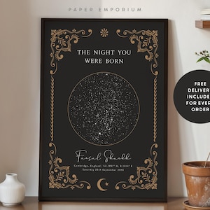 May include: A framed black and gold star map print. The print features a detailed star chart within a circular design, with the text "THE NIGHT YOU WERE BORN" at the top. The name "Faisal Shaikh" and date are at the bottom. Decorative floral elements frame the print.