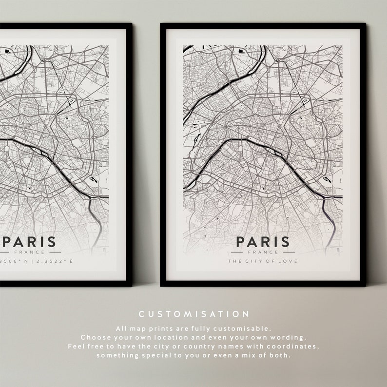May include: Two black framed prints of a map of Paris, France. The top print has the text "Paris, France" and coordinates. The bottom print has the text "Paris, France - The City of Love".