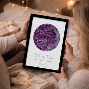 May include: A framed print showing a purple celestial map with constellations. The print includes the names "Caleb & Freya" and the text "Every day since has been ours." The frame is black.