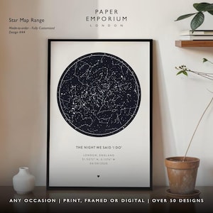 May include: Framed star map print with a black frame. The print features a dark blue celestial map with white stars, and text that reads "THE NIGHT WE SAID 'I DO'". The print also includes the location and date. The words "ANY OCCASION | PRINT, FRAMED OR DIGITAL | OVER 50 DESIGNS" are at the bottom.
