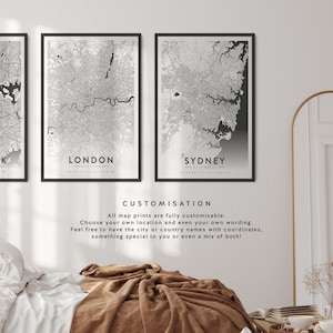 May include: Three black framed prints of city maps with the city names and coordinates printed below each map. The maps are in black and white and show the street layout of the cities. The text below the maps reads "CUSTOMISATION" and "All map prints are fully customisable. Choose your own location and even your own wording. Feel free to have the city or country names with coordinates, something special to you or even a mix of both!"