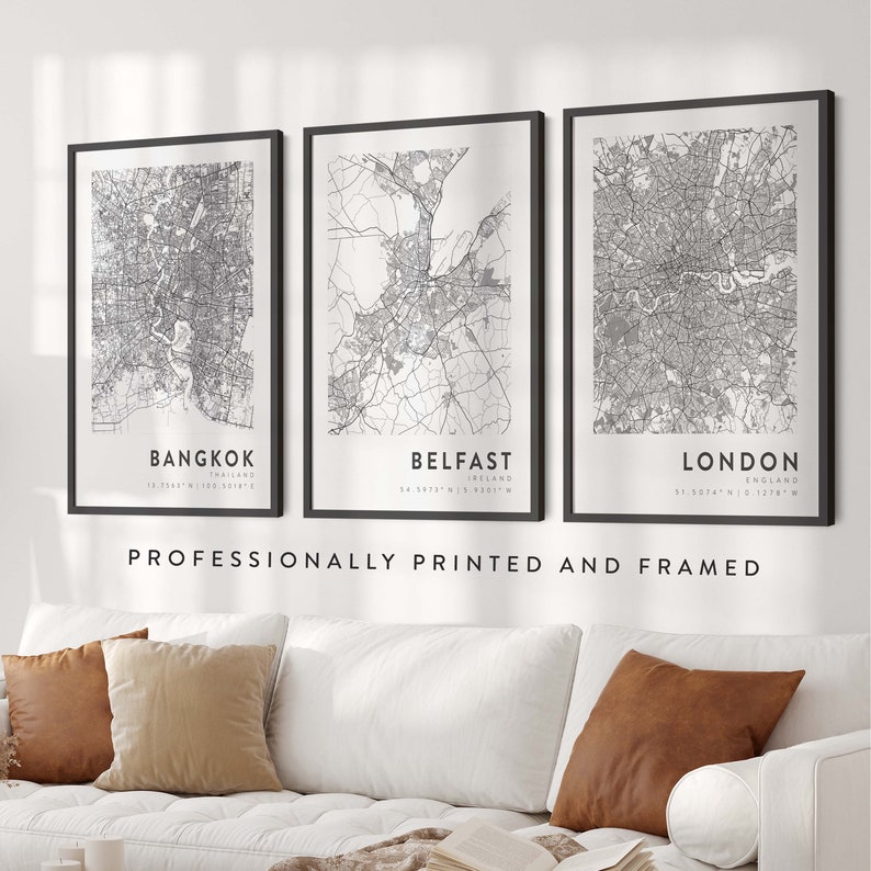 May include: Three black framed prints of city maps with the city names and coordinates printed below each map. The maps are of Bangkok, Thailand; Belfast, Ireland; and London, England. The text "Professionally Printed and Framed" is printed below the maps.