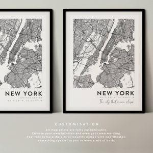 May include: Two black framed prints of a map of New York City with the text "New York" and the coordinates "40.7128 N, 74.0060 W". The print on the right also includes the text "The city that never sleeps".