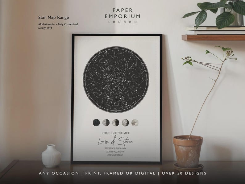 May include: Framed star map print with a black and white celestial design. The print includes the text "THE NIGHT WE MET" and names. The print is displayed on a wall with a small white vase and a potted plant.