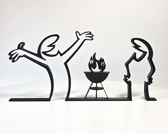 May include: A black, three-piece decorative sculpture set featuring two stylized figures and a central barbecue grill with flames. The figures are depicted in a minimalist line-art style, with one figure gesturing with arms raised and the other standing.