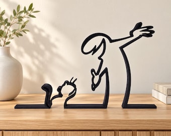 May include: A black metal sculpture featuring a continuous line design that depicts a person standing and dabbing while interacting with a small cat sitting on the ground. The piece is composed of three separate flat-based segments.